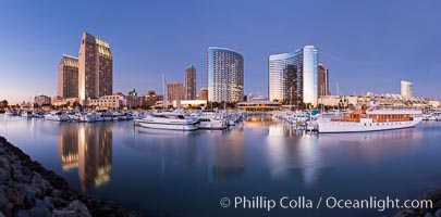 Panoramic photo of San Diego embarcadero, showing the San Diego Marriott Hotel and Marina (center), Roy's Restaurant (center) and Manchester Grand Hyatt Hotel (left) viewed from the San Diego Embarcadero Marine Park