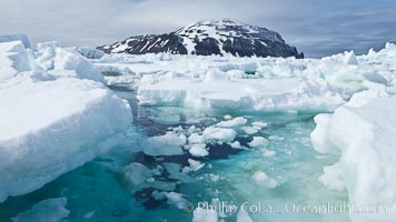 Paulet Island, near the Antarctic Peninsula, is a cinder cone flanks by lava flows on which thousands of Adelie Penguins nest