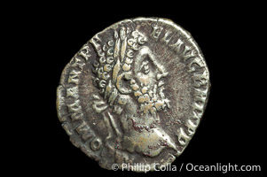 Roman emperor Commodus (177-192 A.D.), depicted on ancient Roman coin (silver, denom/type: Denarius) (AR , Denarius Obverse: M.COMM.ANT.P.FEL.AVG.BRIT.PP. Reverse: GEN.AVG.FLIC.COS.VI.  Genius standing left sacrificing scepter from a patera over an alter.)