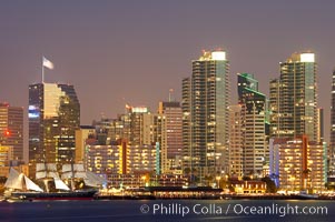 San Diego city skyline at dusk, viewed from Harbor Island, the Star of India at left