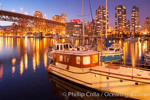 Yaletown section of Vancouver at night, including Granville Island bridge (left), viewed from Granville Island with sailboat in the foreground