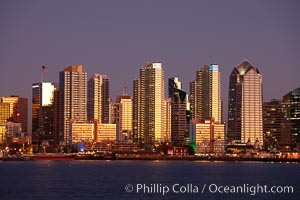 San Diego city skyline at sunset, showing the buildings of downtown San Diego rising above San Diego Harbor, viewed from Harbor Island