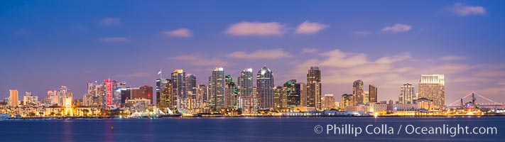 San Diego city skyline at sunrise, showing the buildings of downtown San Diego rising above San Diego Harbor, viewed from Harbor Island