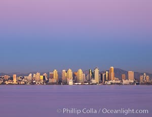 San Diego downtown city skyline and waterfront, sunset reflections and San Diego Bay. Earth-shadow (Belt of Venus) visible in the atmosphere