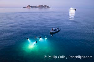 SCUBA Divers at Night, Isla de la Guarda Island, aerial photo, Sea of Cortez. Dive boat Rocio del Mar is seen in the distance. Night diving is scary so I stay on the big boat and fly my drone, Isla Angel de la Guarda, Baja California, Mexico