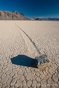 A sliding rock of the Racetrack Playa.  The sliding rocks, or sailing stones, move across the mud flats of the Racetrack Playa, leaving trails behind in the mud.  The explanation for their movement is not known with certainty, but many believe wind pushes the rocks over wet and perhaps icy mud in winter, Death Valley National Park, California