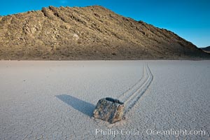 A sliding rock of the Racetrack Playa.  The sliding rocks, or sailing stones, move across the mud flats of the Racetrack Playa, leaving trails behind in the mud.  The explanation for their movement is not known with certainty, but many believe wind pushes the rocks over wet and perhaps icy mud in winter, Death Valley National Park, California