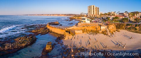 South Casa Cove and Childrens Pool sea wall, with tourist crowds at sunset on a low tide, La Jolla