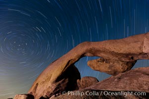 Star trails and Arch Rock.  Polaris, the North Star, is at the center of the circular arc star trails as they pass above this natural stone archway in Joshua Tree National Park