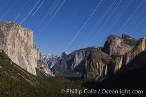 Star trails over Yosemite Valley, viewed from Tunnel View, the floor of Yosemite Valley illuminated by a full moon.  El Capitan on left, Bridalveil Falls on right, Half Dome in distant center, Yosemite National Park, California