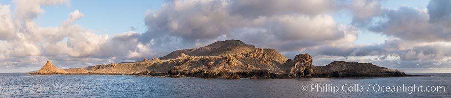 Sunrise at San Clemente Island, south end showing China Hat (Balanced Rock) and Pyramid Head, near Pyramid Cove, storm clouds. Panoramic photo