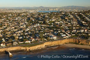 Sunset Cliffs, a coastal community of San Diego, boasts beautiful homes and rugged, scalloped bluffs rising above the Pacific Ocean.  Downtown San Diego can be seen in the distance