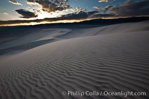 Sunset on the Eureka Dunes.  The Eureka Valley Sand Dunes are California's tallest sand dunes, and one of the tallest in the United States.  Rising 680' above the floor of the Eureka Valley, the Eureka sand dunes are home to several endangered species, as well as "singing sand" that makes strange sounds when it shifts.  Located in the remote northern portion of Death Valley National Park, the Eureka Dunes see very few visitors