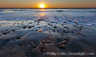 Sunset and incoming surf, gorgeous colors in the sky and on the ocean at dusk, the incoming waves are blurred in this long exposure, Carlsbad, California