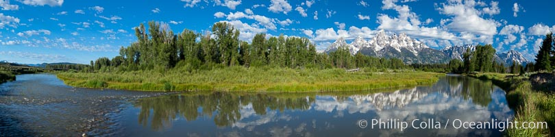 Panoramic photo of the Teton Range, reflected in the still waters of Schwabacher Landing, a sidewater of the Snake River, Grand Teton National Park, Wyoming