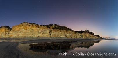 Torrey Pines Cliffs lit at night by a full moon, low tide reflections, Torrey Pines State Reserve, San Diego, California