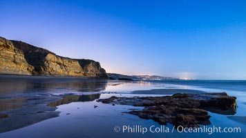 Torrey Pines Cliffs lit at night by a full moon, low tide reflections, Torrey Pines State Reserve, San Diego, California