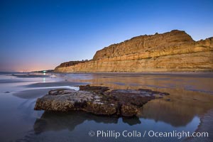 Torrey Pines Cliffs lit at night by a full moon, low tide reflections, Torrey Pines State Reserve, San Diego, California