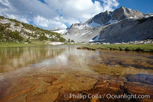 Townsley Lake (10396'), a beautiful alpine lake sitting below blue sky, clouds and Fletcher Peak (right), lies amid the Cathedral Range of glacier-sculpted granite peaks in Yosemite's high country, near Vogelsang High Sierra Camp, Yosemite National Park, California