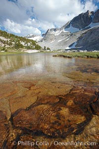 Townsley Lake, a beautiful alpine lake sitting below blue sky, clouds and Fletcher Peak (right), lies amid the Cathedral Range of glacier-sculpted granite peaks in Yosemite's high country, near Vogelsang High Sierra Camp, Yosemite National Park, California