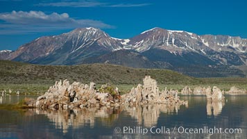 Tufa towers rise from Mono Lake, with the Eastern Sierra visible in the distance. Tufa towers are formed when underwater springs rich in calcium mix with lakewater rich in carbonates, forming calcium carbonate (limestone) structures below the surface of the lake. The towers were eventually revealed when the water level in the lake was lowered starting in 1941