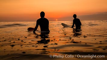 Two surfers at sunset, blood red dusk, Encinitas