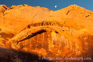 Setting moon over natural sandstone arch, sunrise, Valley of Fire State Park
