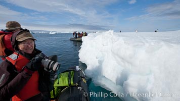 Visitors enjoy a look at penguins on an iceberg from an inflatable boat, Paulet Island