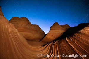 The Wave at Night, under a clear night sky full of stars.  The Wave, an area of fantastic eroded sandstone featuring beautiful swirls, wild colors, countless striations, and bizarre shapes set amidst the dramatic surrounding North Coyote Buttes of Arizona and Utah. The sandstone formations of the North Coyote Buttes, including the Wave, date from the Jurassic period. Managed by the Bureau of Land Management, the Wave is located in the Paria Canyon-Vermilion Cliffs Wilderness and is accessible on foot by permit only
