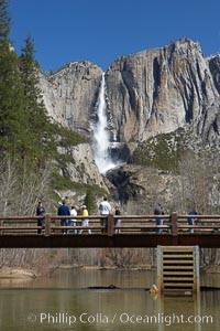 Visitors admire Yosemite Falls from the Swinging Bridge, Leidig Meadow, Yosemite National Park, California