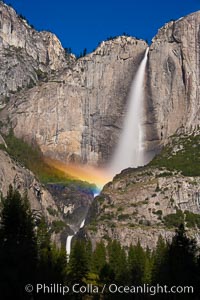 Upper Yosemite Falls and lunar rainbow, moonbow. A lunar rainbow (moonbow) can be seen to the left of Yosemite Falls, where the moon illuminates the spray of the falls, Yosemite National Park, California