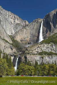 Yosemite Falls rises above Cooks Meadow.  The 2425 falls, the tallest in North America, is at peak flow during a warm-weather springtime melt of Sierra snowpack.  Yosemite Valley, Yosemite National Park, California