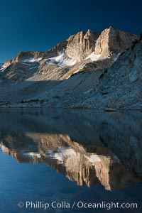 Cathedral Range peaks reflected in the still waters of Townsley Lake at sunrise, Yosemite National Park, California