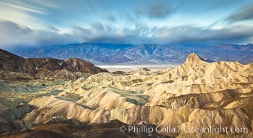 Zabriskie Point sunrise, clouds blurred by long time exposure, Death Valley National Park, California