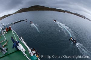 Zodiac boats, are lowered into the ocean from the ship M/V Polar Star in preparation for a day exploring New Island in the Falklands