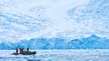 Zodiac cruising in Antarctica.  Tourists enjoy the pack ice and towering glaciers of Cierva Cove on the Antarctic Peninsula