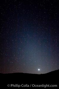 Zodiacal light over Death Valley.  Zodiacal light is a faint diffuse light seen along the plane of the ecliptic in the vicinity of the setting or rising sun, caused by sunlight scattered off space dust in the zodiacal cloud, Racetrack Playa, Death Valley National Park, California