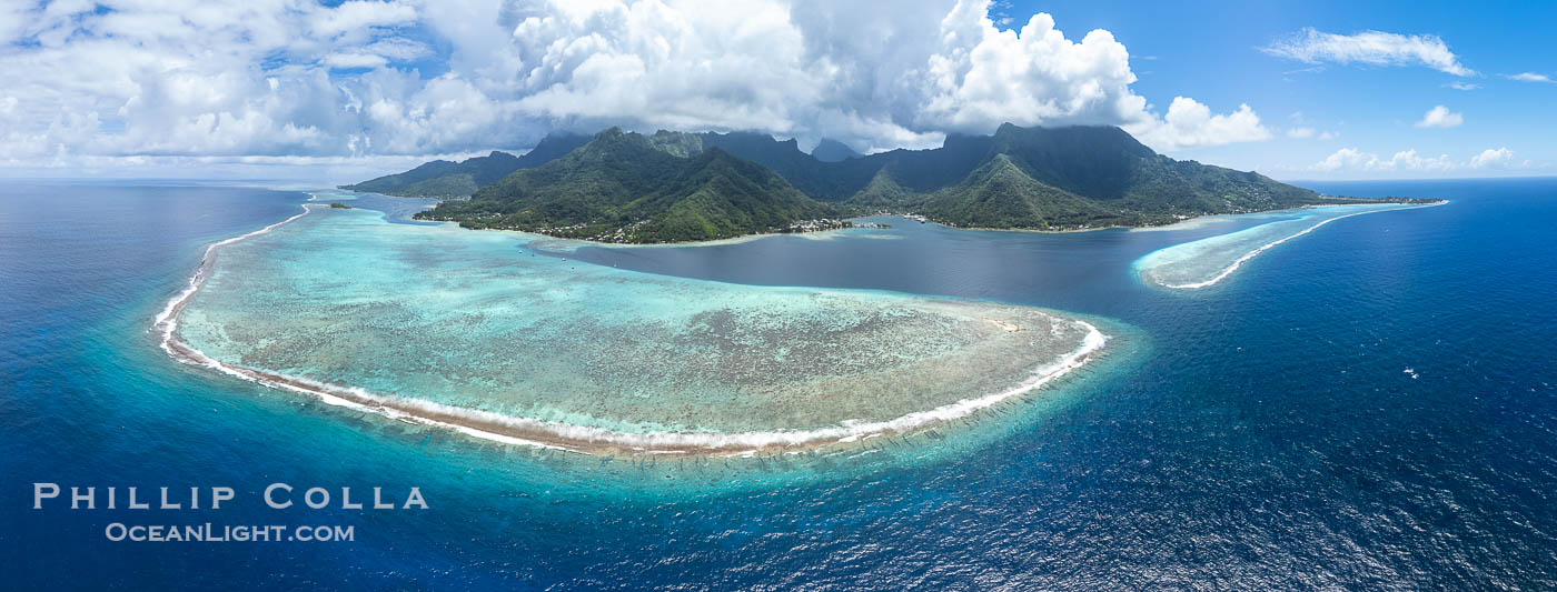 Barrier Reef around Moorea Island, French Polynesia. The outer reef slope is seen adjacent to deep blue oceanic water with white waves breaking against the reef edge. Next, a wide shallow reef flat occurs dotted with coral bommies. Inside of that, a shallow protected lagoon is formed against the island.  Tall, rugged, eroded mountains are seen hinting at the age of the ancient volcano that originally formed the island and that is now sinking back down, leaving the encircling reef behind. France, natural history stock photograph, photo id 40678