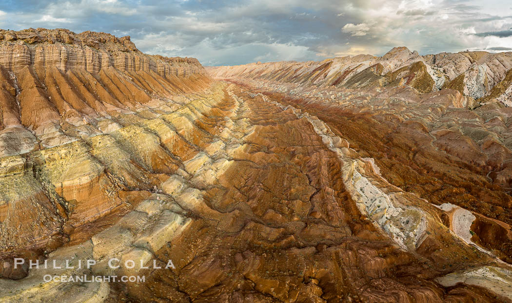 Aerial View of the San Rafael Reef, Utah.  This is a canyon-like section of the San Rafael Reef, photographed at sunrise. The "reef proper" is on the right, with its characteristic triangular flatiron erosion. The canyon in the center is a fold in the Earth's crust affiliated with the boundary of the San Rafael Swell.  The colors seen here arise primarily from Navajo and Wingate sandstone. USA, natural history stock photograph, photo id 39496