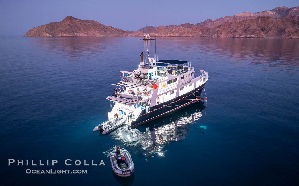 Dive boat Rocio del Mar anchored at  Isla Angel de la Guarda at Sunset, Aerial Photo, Sea of Cortez, Mexico.  Guardian Angel island is part of the Midriff Islands in Mexico's Sea of Cortez