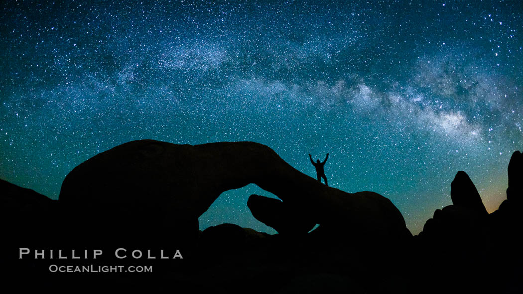 The Milky Way galaxy arches over Arch Rock on a clear evening in Joshua Tree National Park. California, USA, natural history stock photograph, photo id 26792
