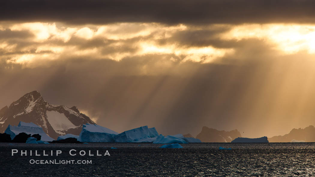 Iceberg, ocean, light and clouds.  Light plays over icebergs and the ocean near Coronation Island. South Orkney Islands, Southern Ocean, natural history stock photograph, photo id 24796